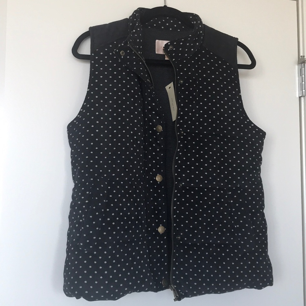 Black puffer vest with white polka dots